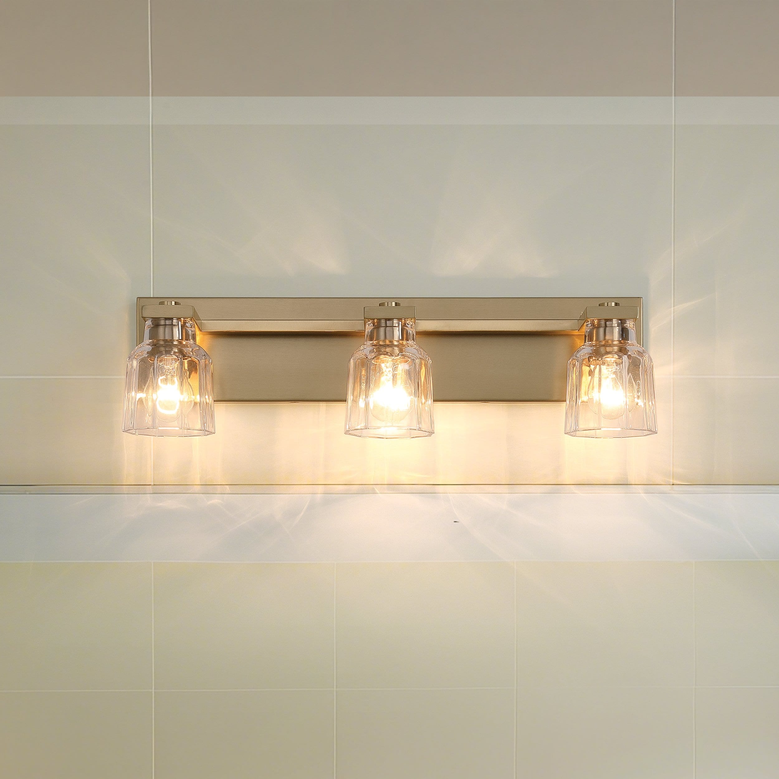 Dryden 24 Inch 3 Light Champagne Gold Vanity Light With Clear Ribbed Glass Shades