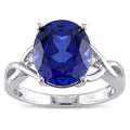 Miadora Sterling Silver Oval Cut Created Blue Sapphire And Diamond Accent Crossover Ring