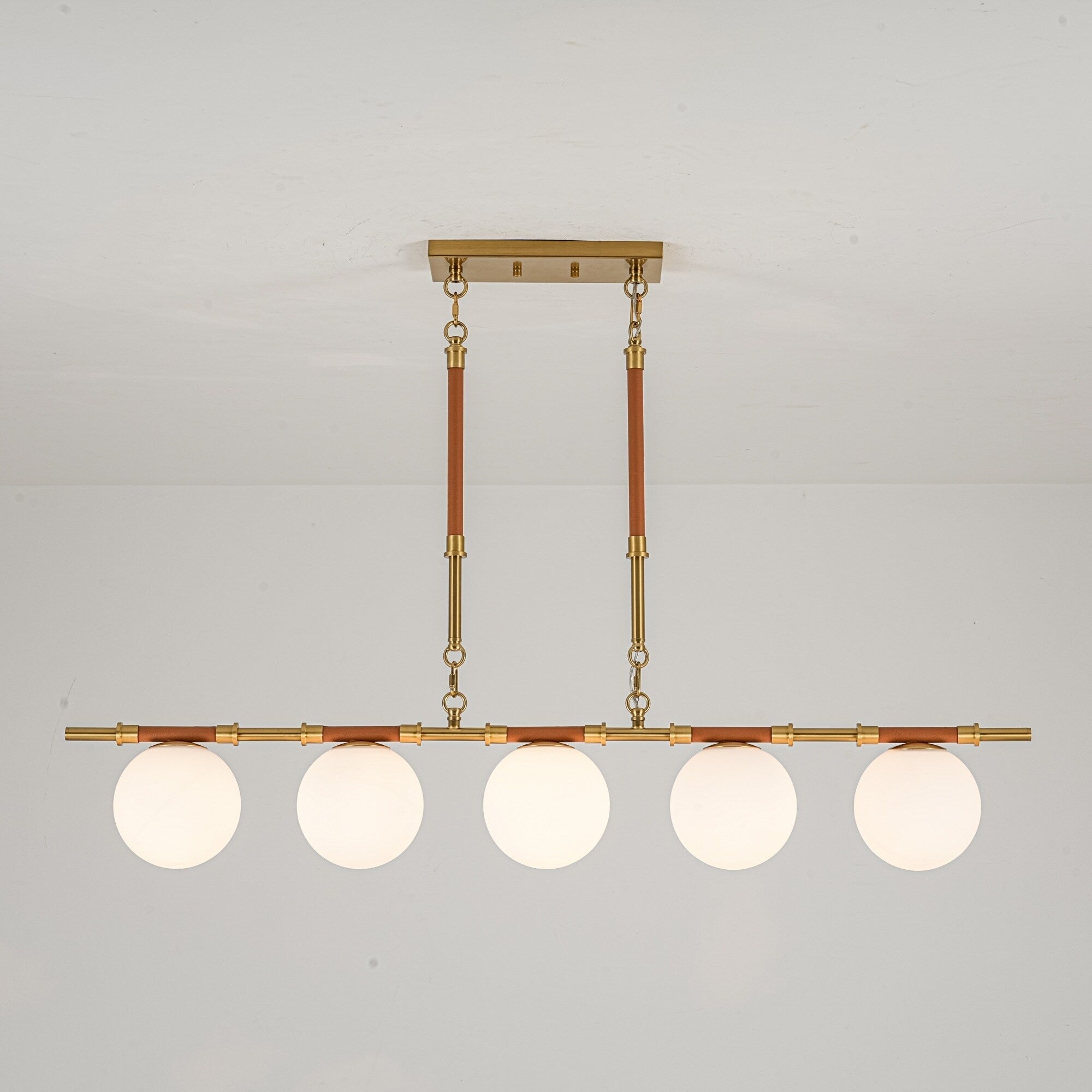 Modern French 5 Light Linear Chandelier In Brushed Brass With Textured Lychee Rods And Opal Globe Shades