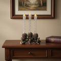 Set Of Three Clear Flameless Taper Candles In Brown And Green Resin Pinecone Holder