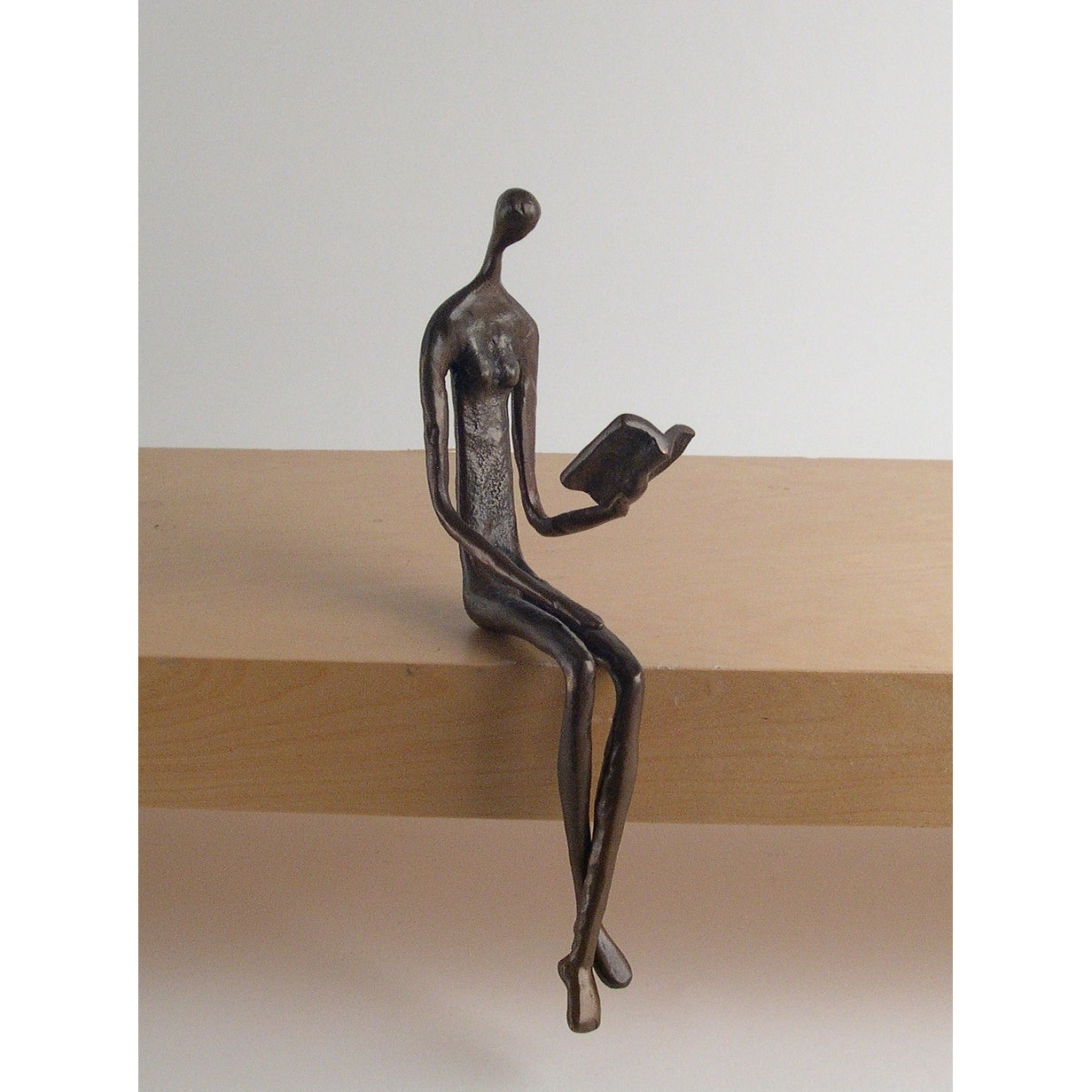 Woman Reading Over Ledge Cast Bronze Sculpture